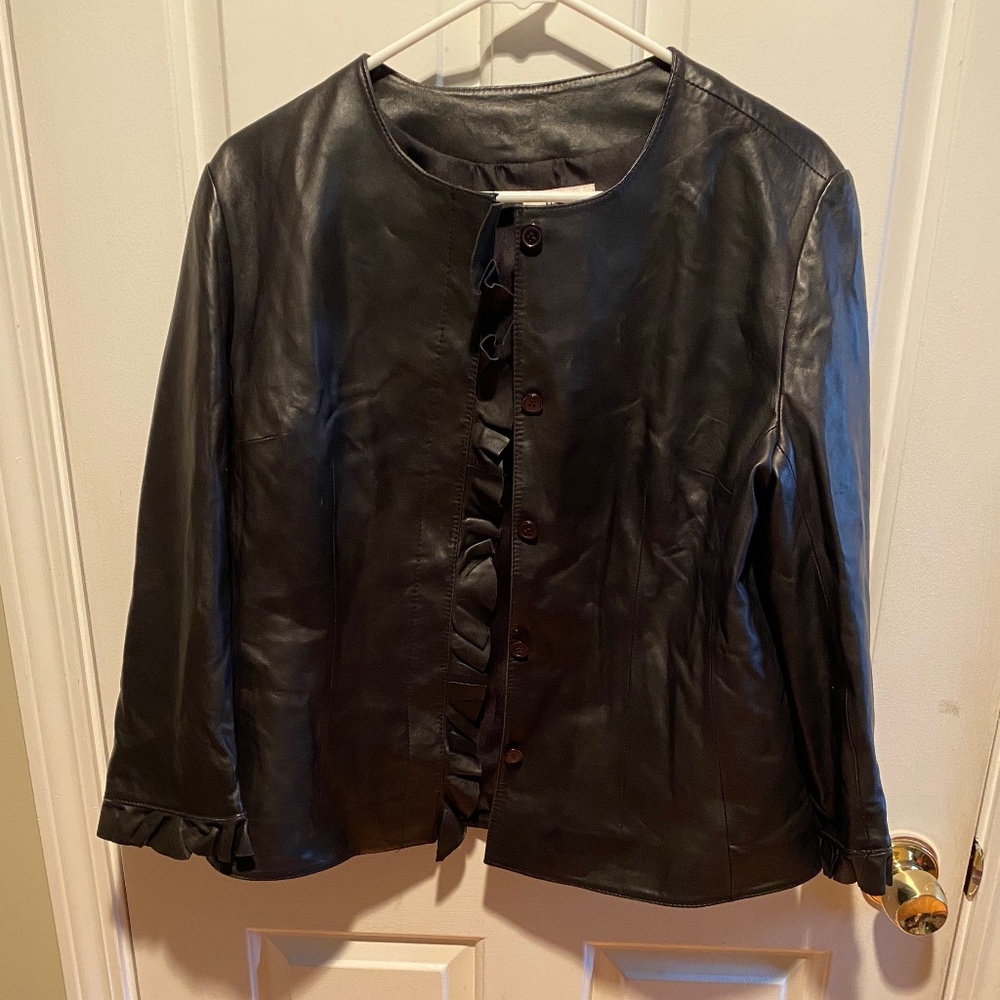 Black leather jacket with ruffles down the front and ruffled sleeve